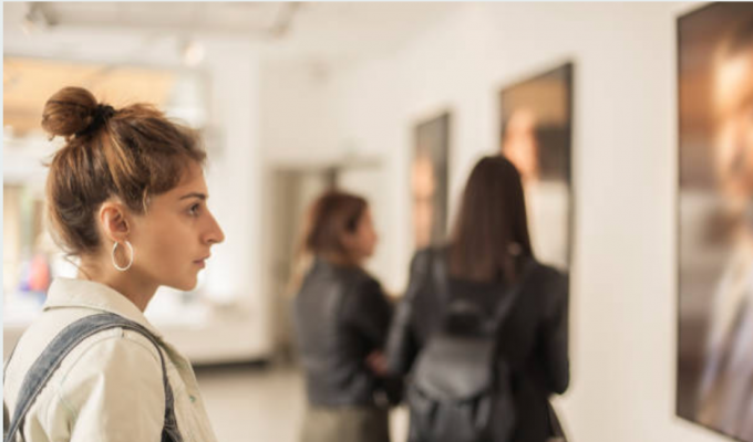 Woman looking at art on the wall in gallery