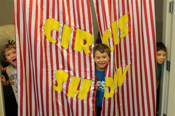 Teach for Us Circus Show kids behind curtain