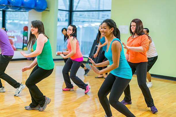 Group of young adults learning how to dance.