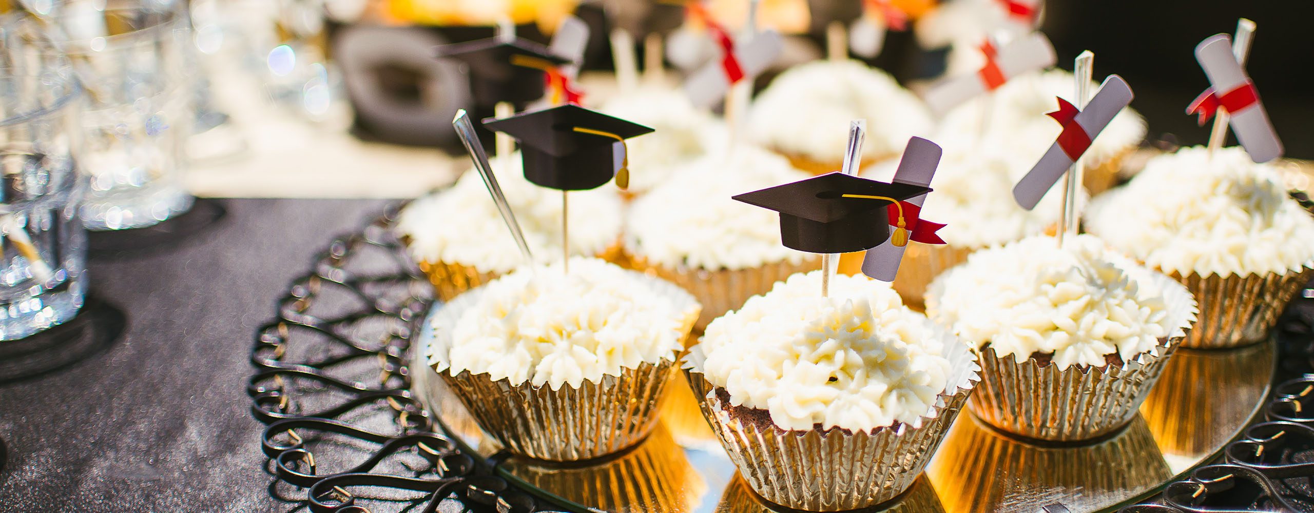 Graduation cupcakes and sparling drink glasses on party table