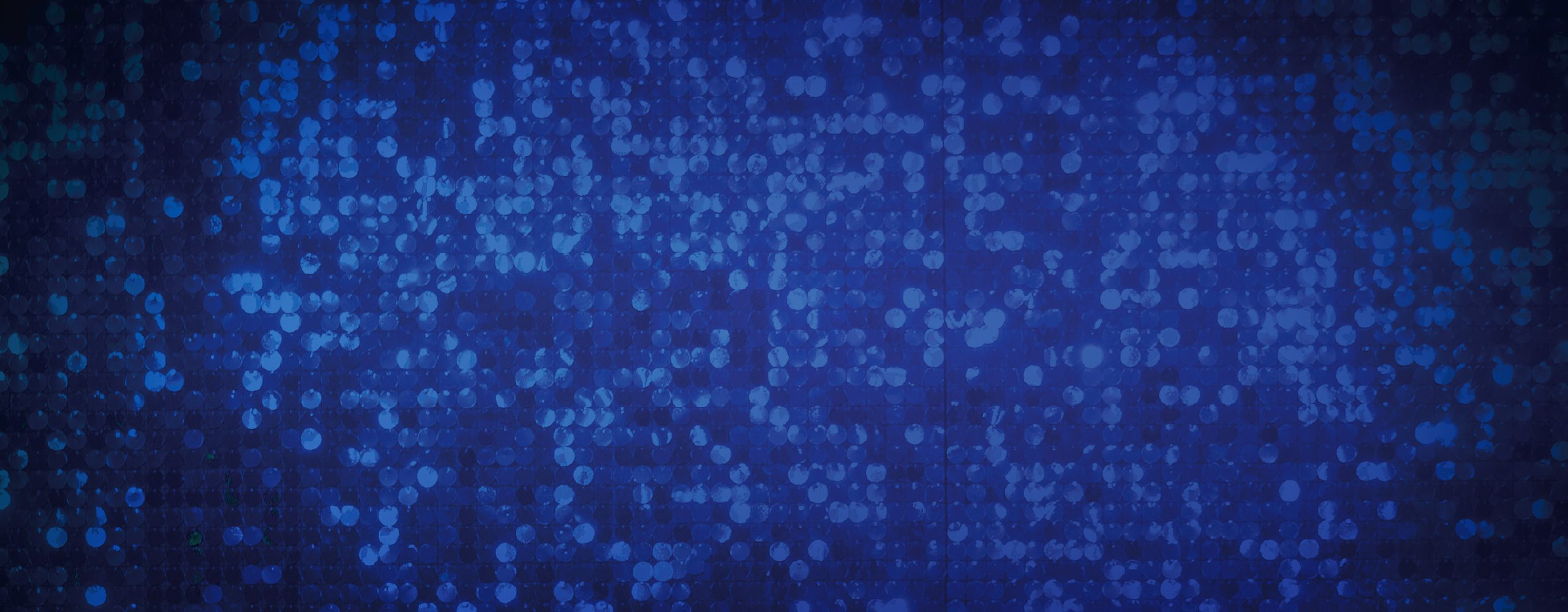 A dark blue, sparkly sequin background