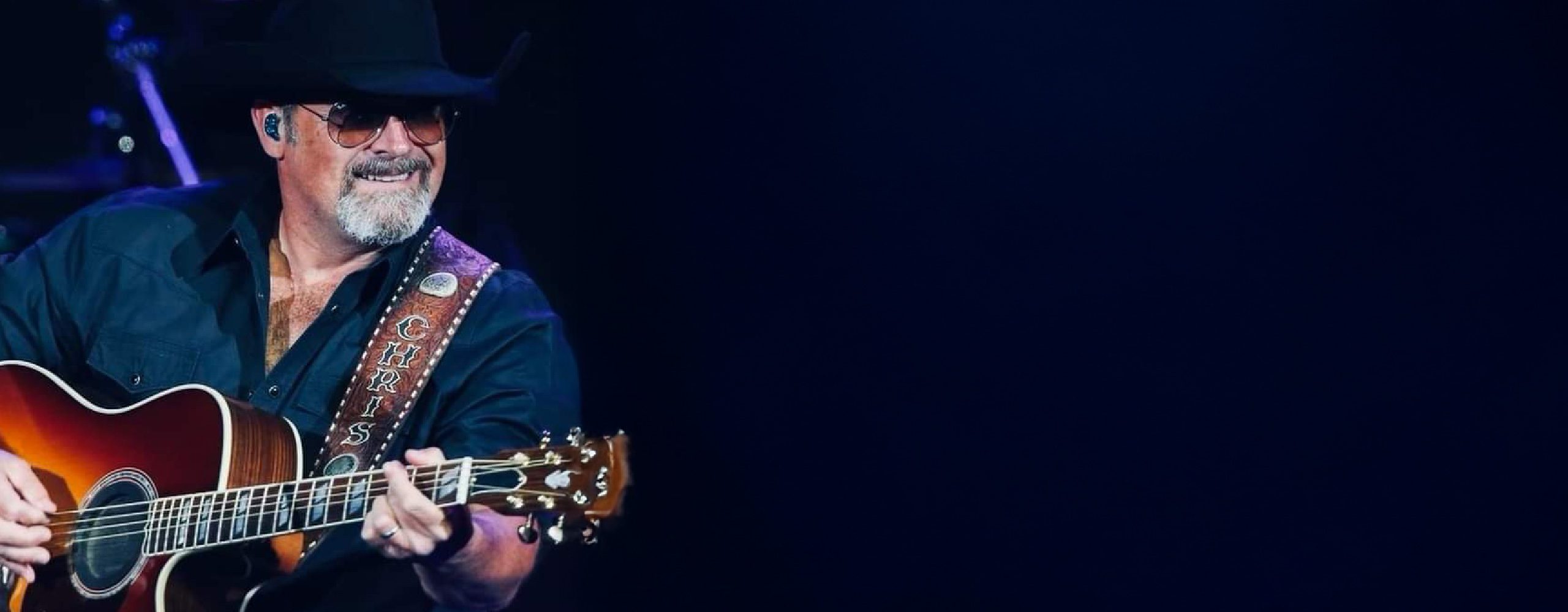 Chris Sagle playing his guitar live on stage.