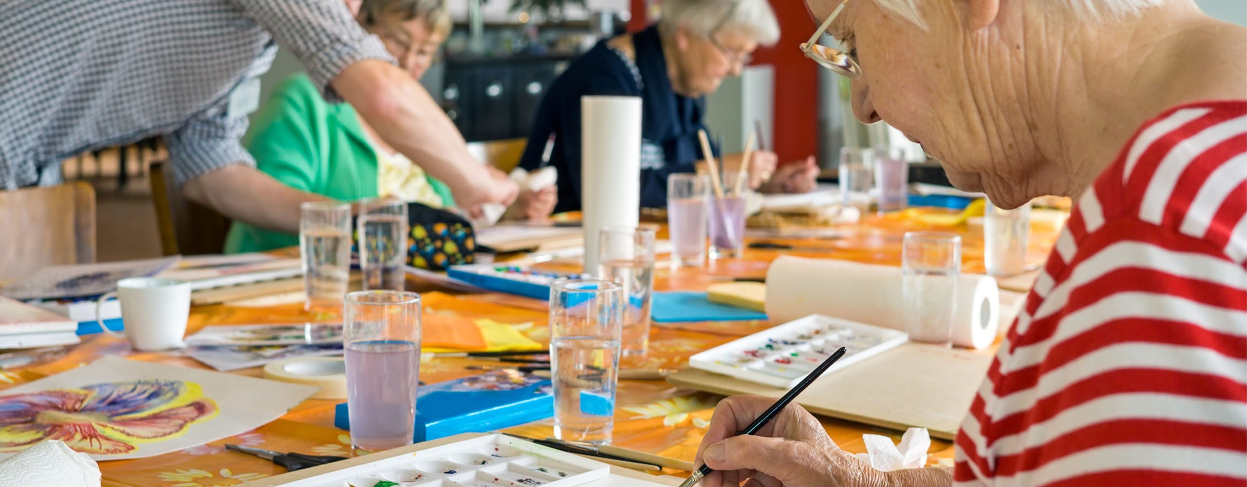 Group of aging adults painting water color paintings