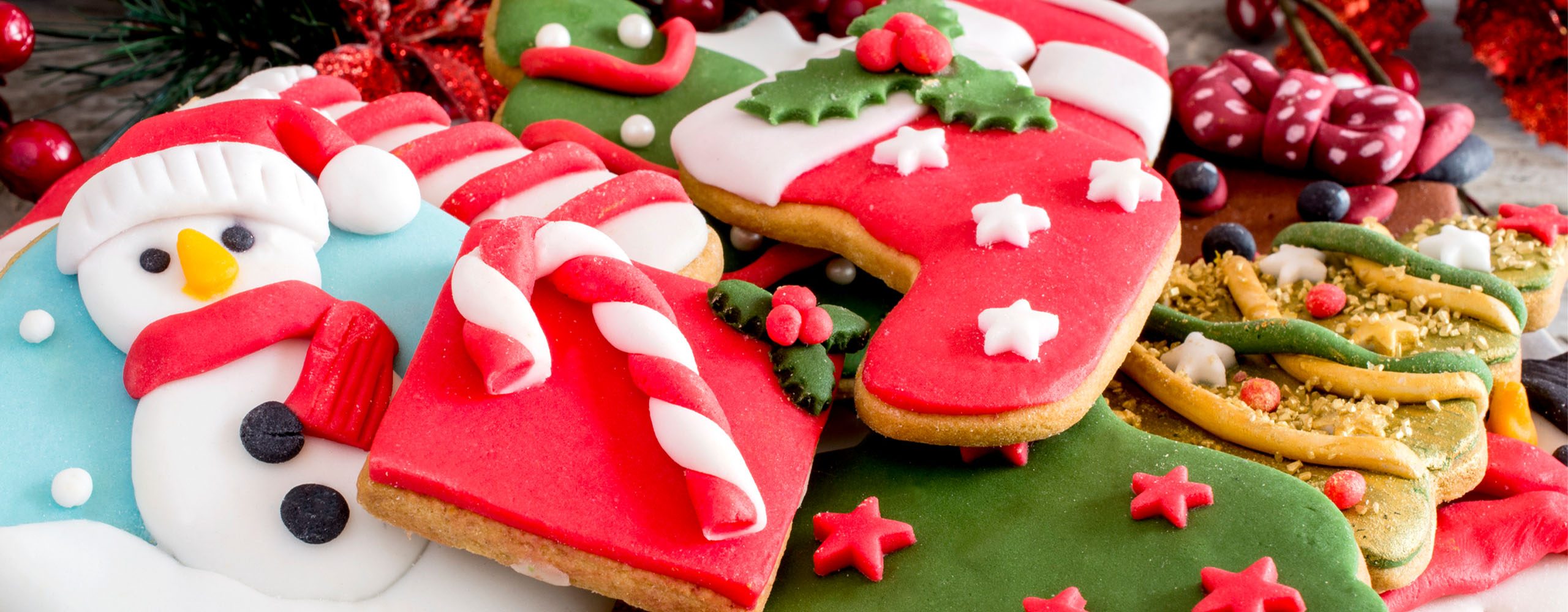 Festive, iced holiday cookies including snowman, candy canes, stocking, and holiday tree
