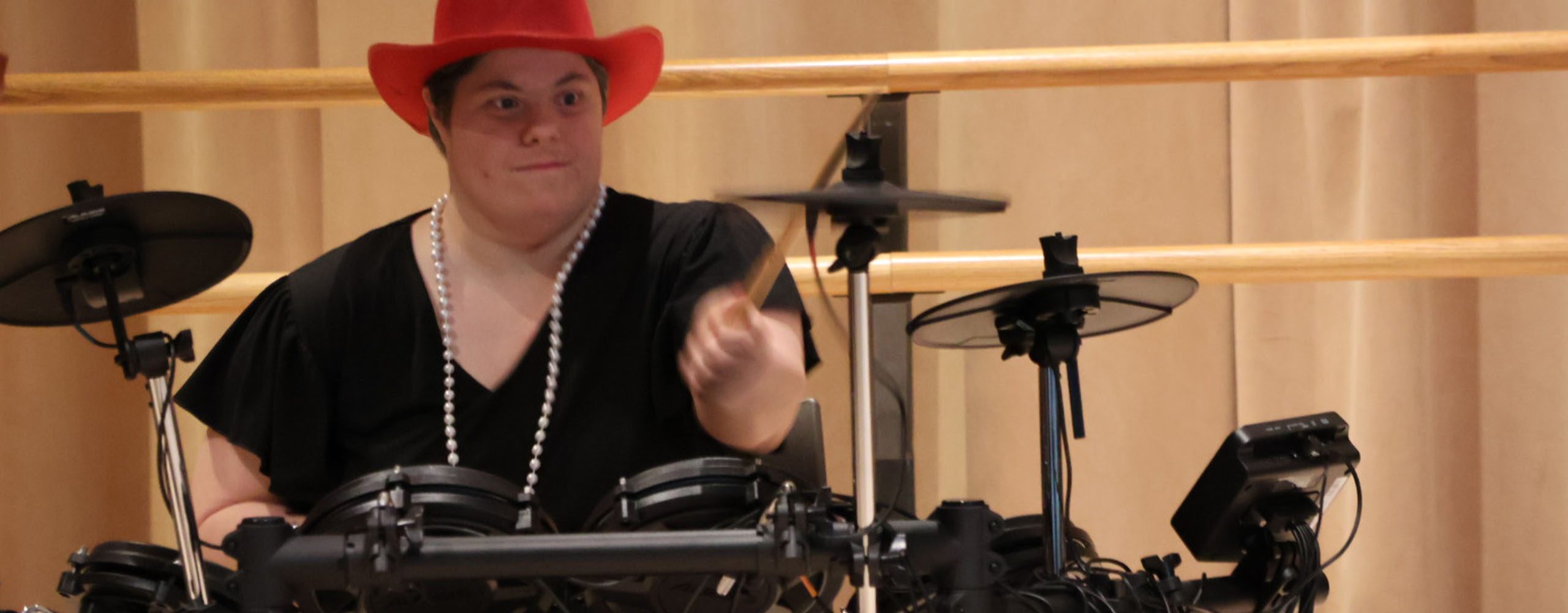 Drummer v2 2560 x 1000 Student playing drums in students with exceptionalities music class