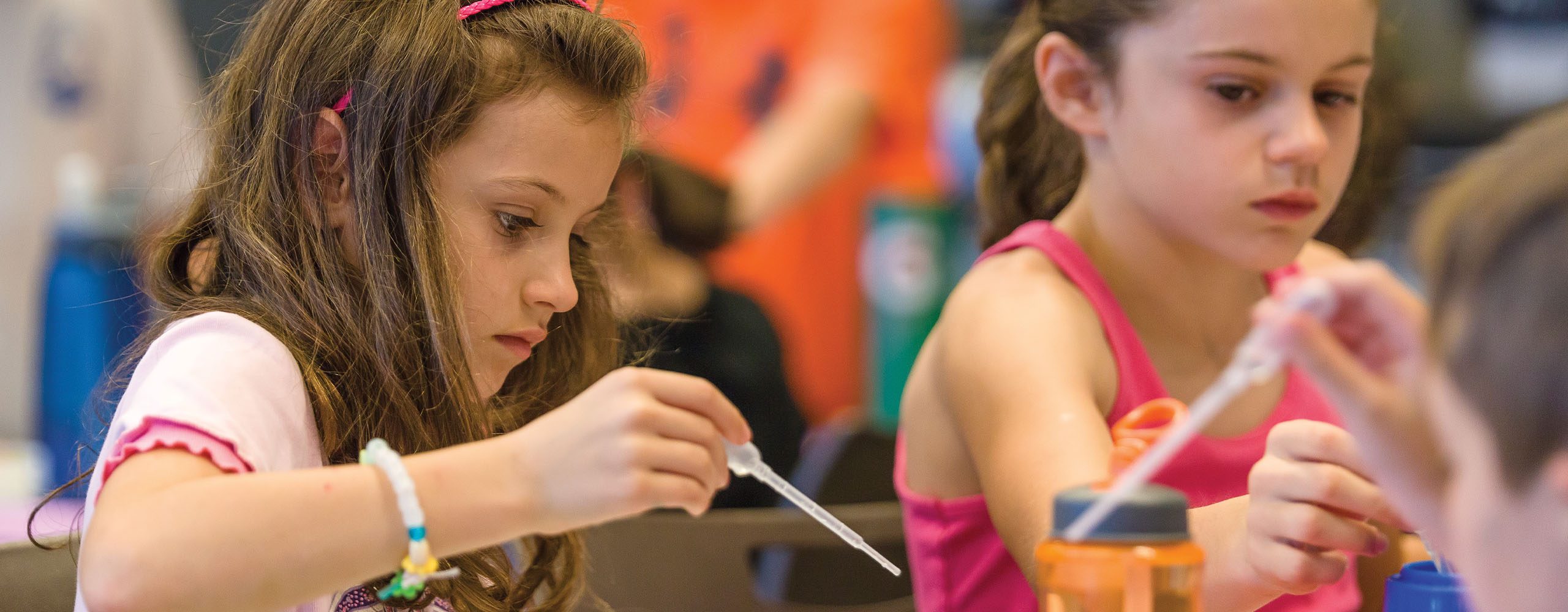 Two young girls working on art project