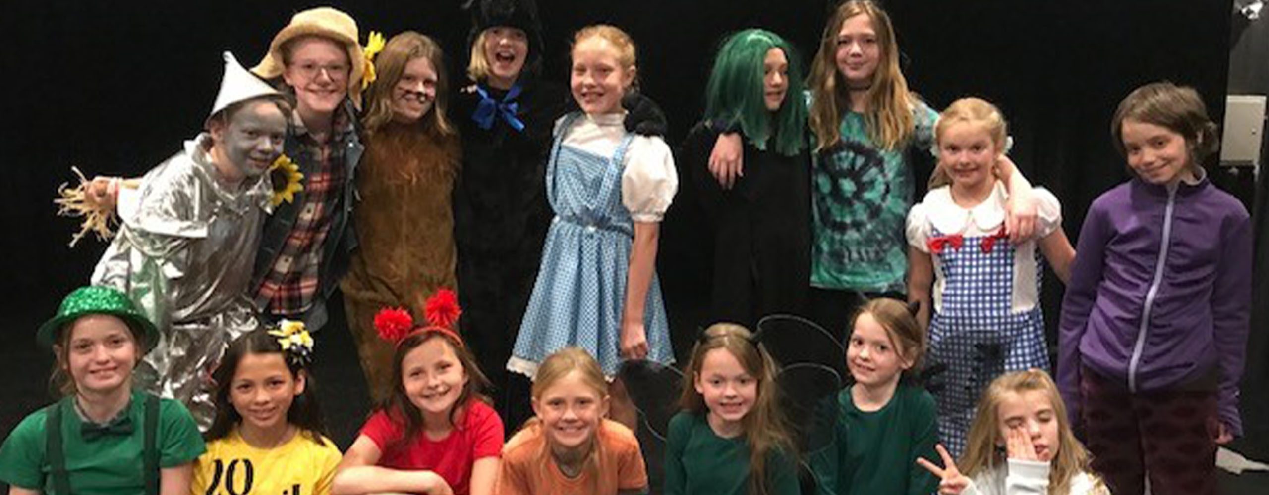 Theater Kids 2 2560 x 1000 young theater performers in costumes from Wizard of Oz stage production