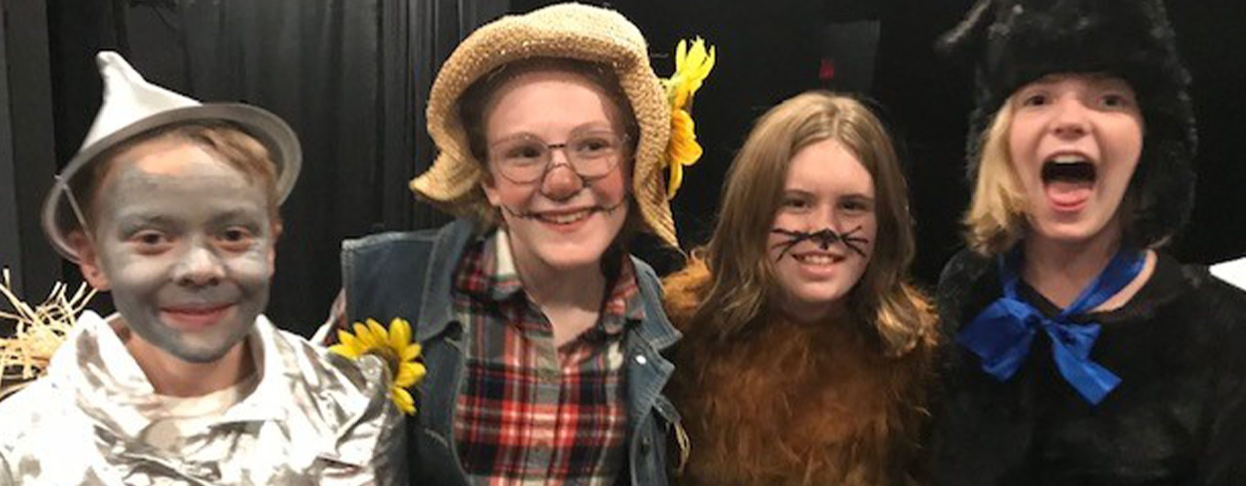 Theater Kids 2560 x 1000 young theater performers in costumes from Wizard of Oz stage production