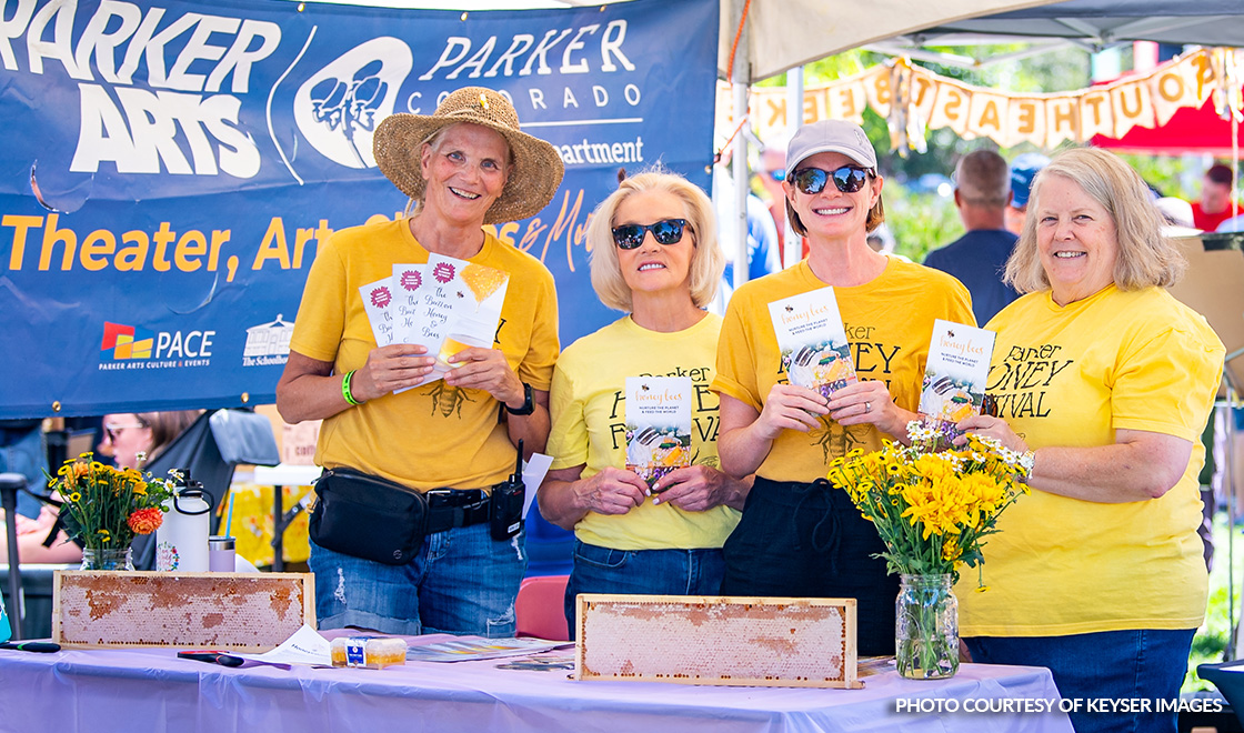 Parker Arts Volunteers at a booth during the Honey Festival