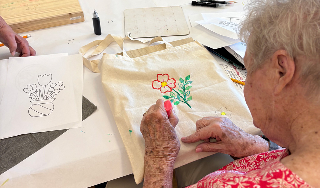 Woman decorating a canvas bag