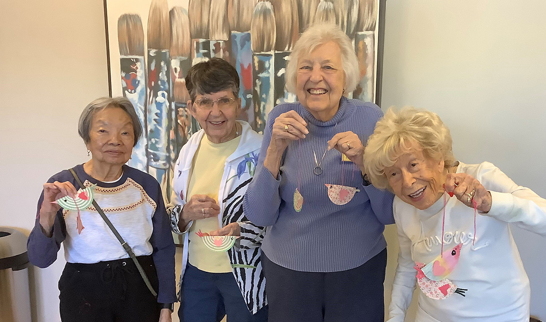 Women holding up crafts that they made