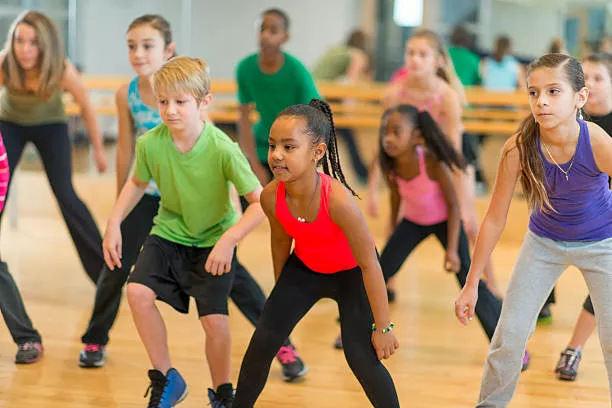 Diverse group of children taking a dance fitness class